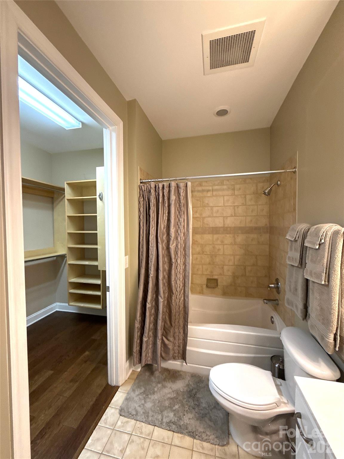 230 South Tryon Street, Unit 1002 Charlotte, NC 28202 - Photo 12 of 19 a bathroom with a sink a toilet and shower