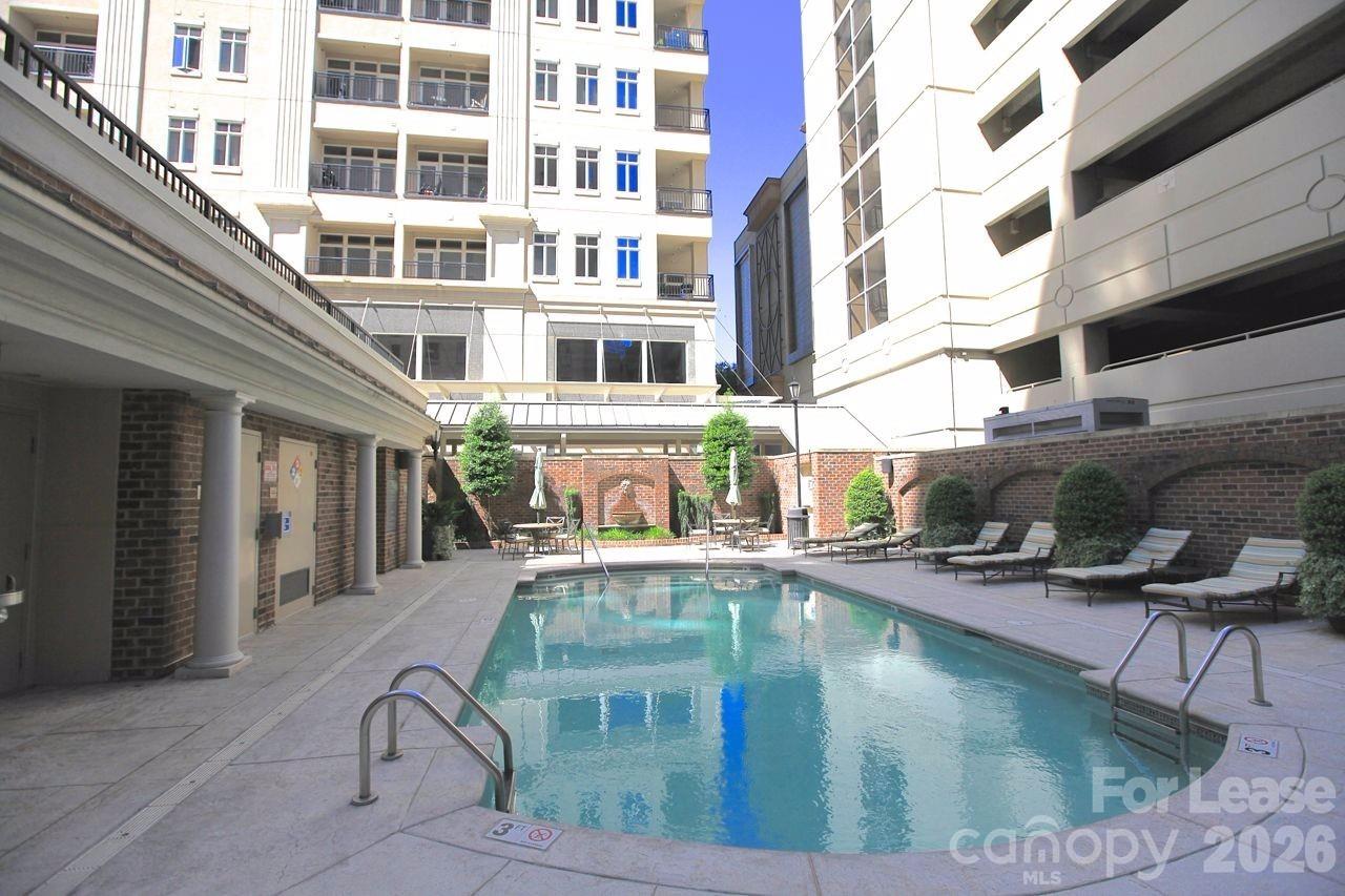 230 South Tryon Street, Unit 1002 Charlotte, NC 28202 - Photo 17 of 19 a view of a swimming pool with a lounge chairs