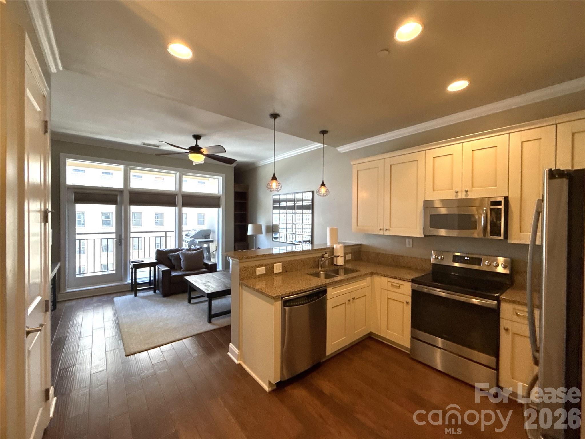 230 South Tryon Street, Unit 1002 Charlotte, NC 28202 - Photo 2 of 19 a kitchen with stainless steel appliances granite countertop a stove and a refrigerator