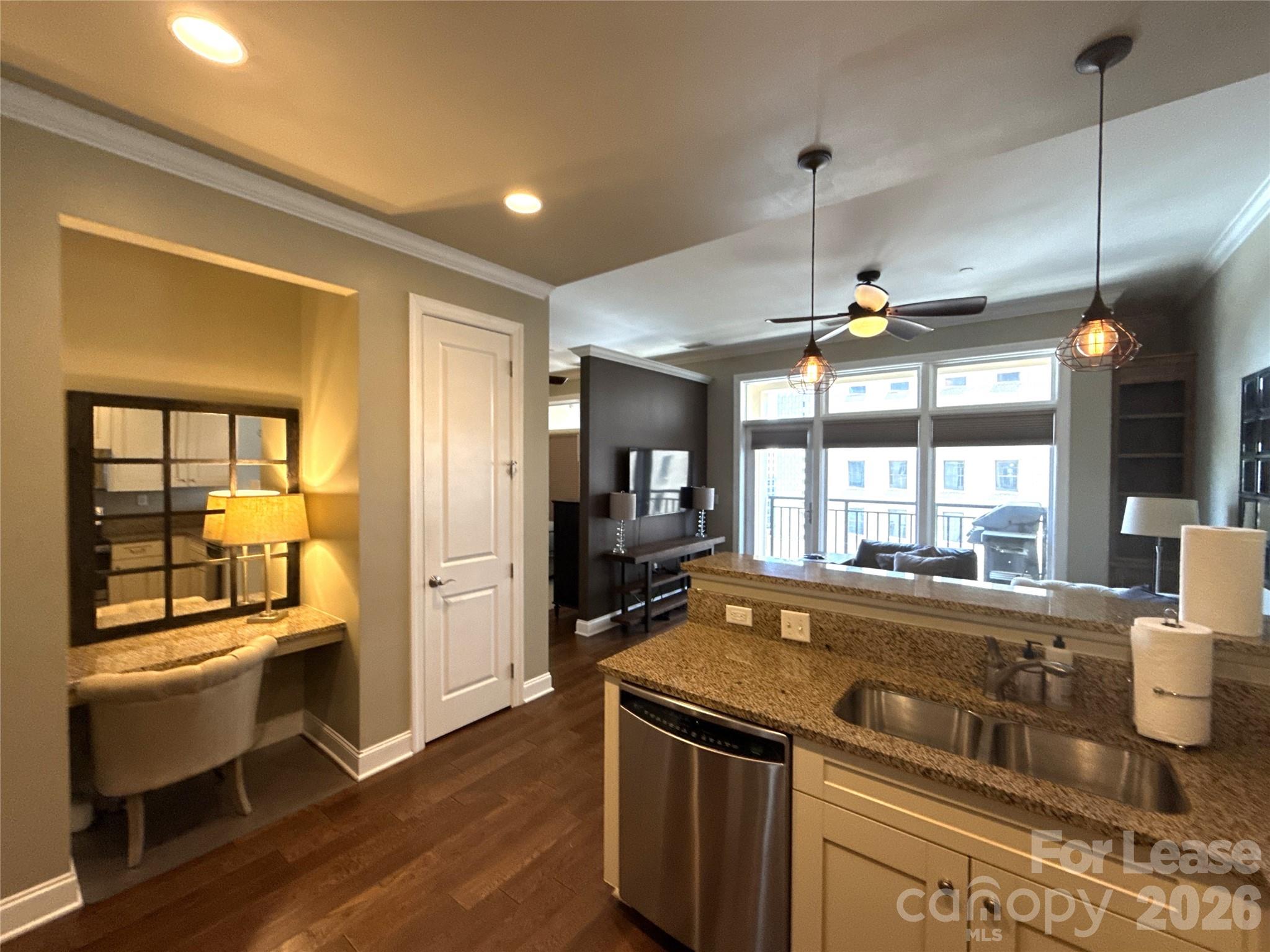 230 South Tryon Street, Unit 1002 Charlotte, NC 28202 - Photo 4 of 19 a kitchen with a stove and a refrigerator