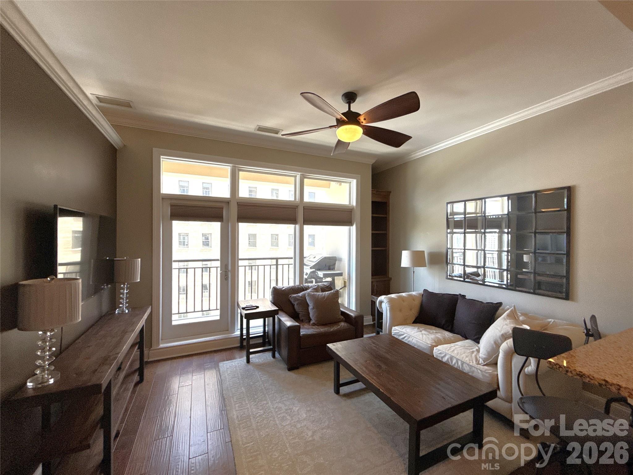 230 South Tryon Street, Unit 1002 Charlotte, NC 28202 - Photo 6 of 19 a living room with furniture and a large window
