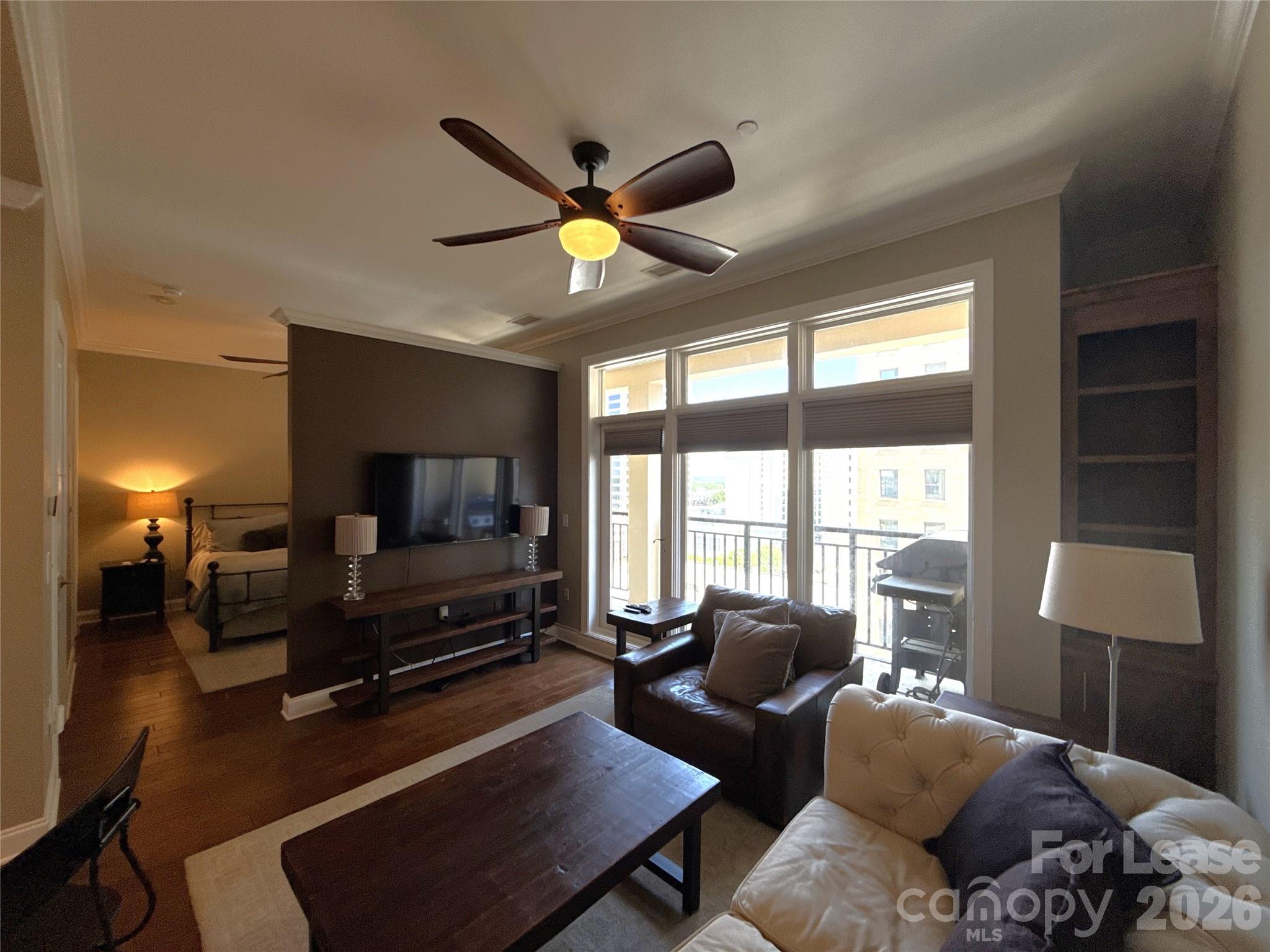230 South Tryon Street, Unit 1002 Charlotte, NC 28202 - Photo 7 of 19 a living room with furniture and a flat screen tv
