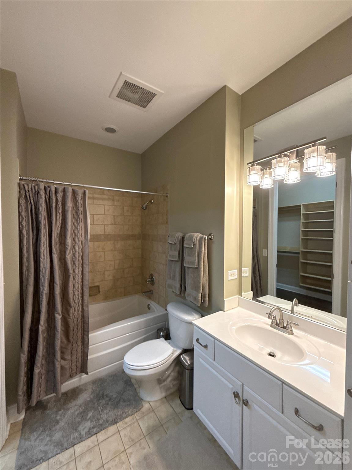 230 South Tryon Street, Unit 1002 Charlotte, NC 28202 - Photo 10 of 19 a bathroom with a double vanity sink toilet and shower