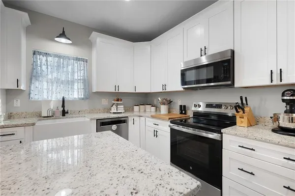 a kitchen with a sink stove and microwave