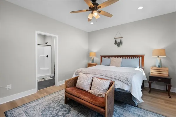 a bedroom with a bed and wooden floor