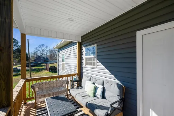 a view of balcony with wooden floor and outdoor seating