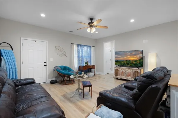 a living room with furniture and a flat screen tv