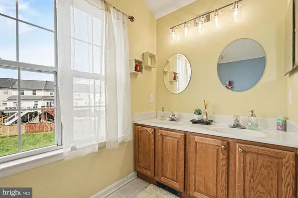 a bathroom with a double vanity sink and a mirror