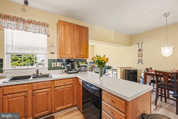 a kitchen with a stove a sink a dining table and chairs