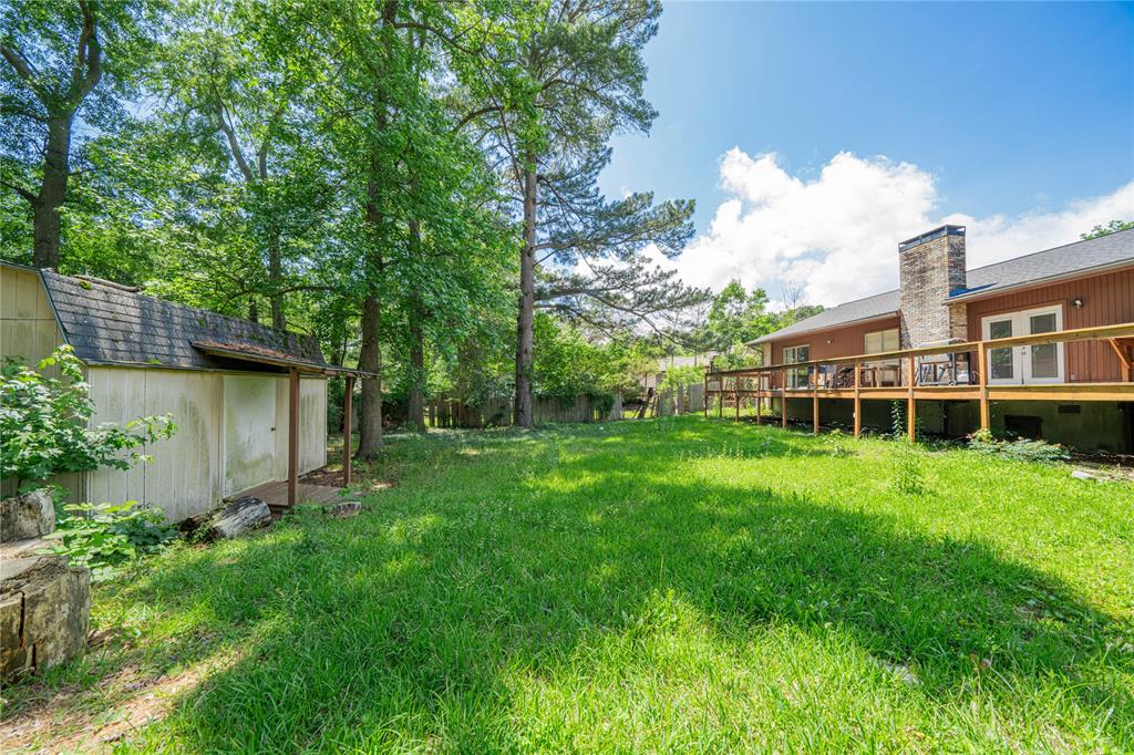 1006 Rikkity Lane Mount Pleasant, TX 75455 - Photo 29 of 39 a view of a house with backyard and garden