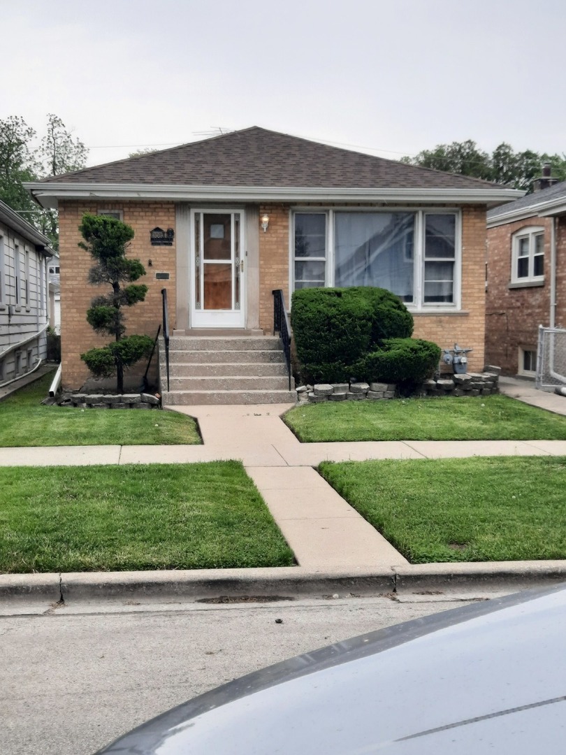 6061 75th Avenue Summit, IL 60501 - Photo 1 of 1 a front view of a house with a yard and garage