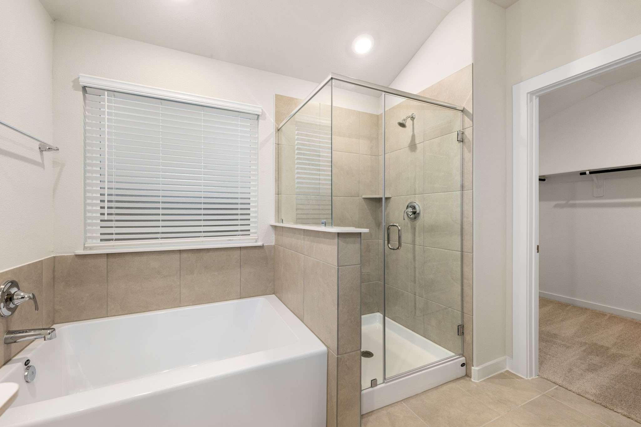 6611 Castella Drive Rosharon, TX 77583 - Photo 26 of 31 A closer view of the primary bathroom with dual sinks, a soaking tub, and a separate glass-enclosed shower.
