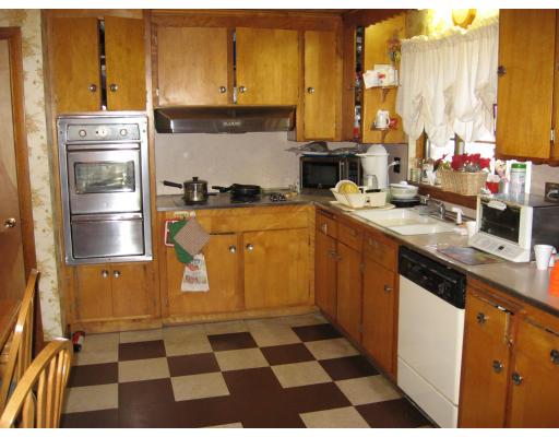 20 Sawmill Brook Road Winchester, MA 01890 - Photo 4 of 12 a kitchen with a refrigerator and a sink