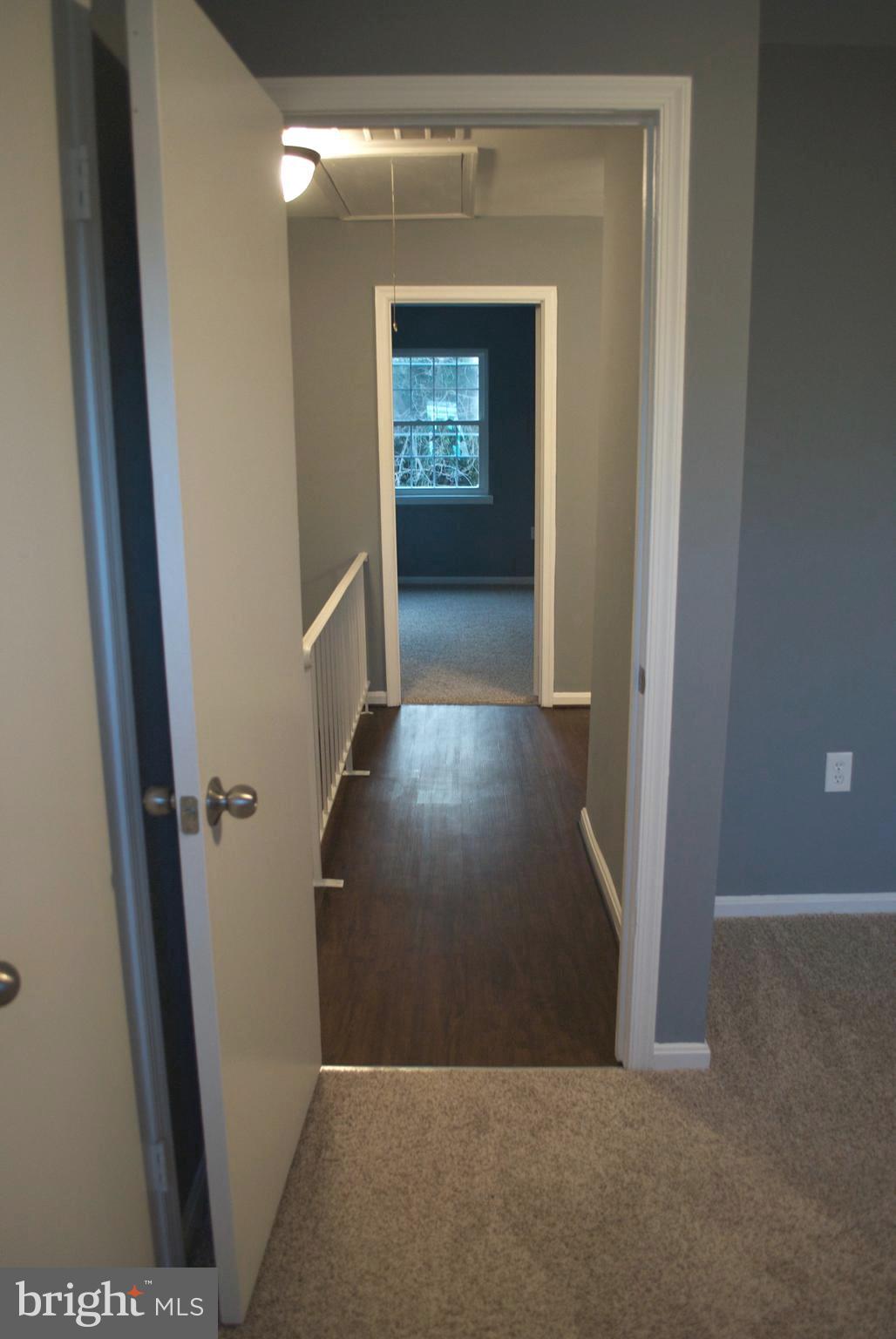 7635 Arbory Court, Unit 65 Laurel, MD 20707 - Photo 13 of 33 a view of a hallway with wooden floor and a living room
