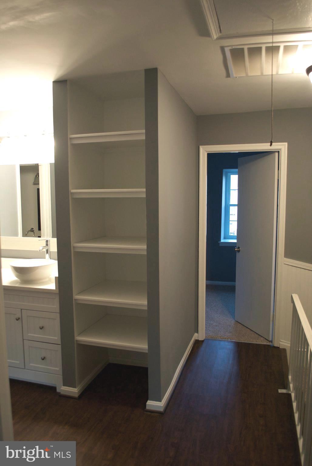 7635 Arbory Court, Unit 65 Laurel, MD 20707 - Photo 17 of 33 a view of an empty room with cabinet and a hallway