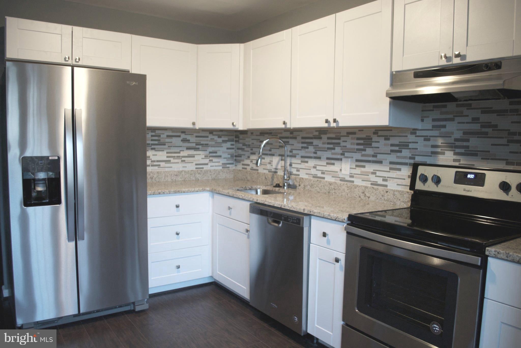 7635 Arbory Court, Unit 65 Laurel, MD 20707 - Photo 3 of 33 a kitchen with granite countertop white cabinets and stainless steel appliances