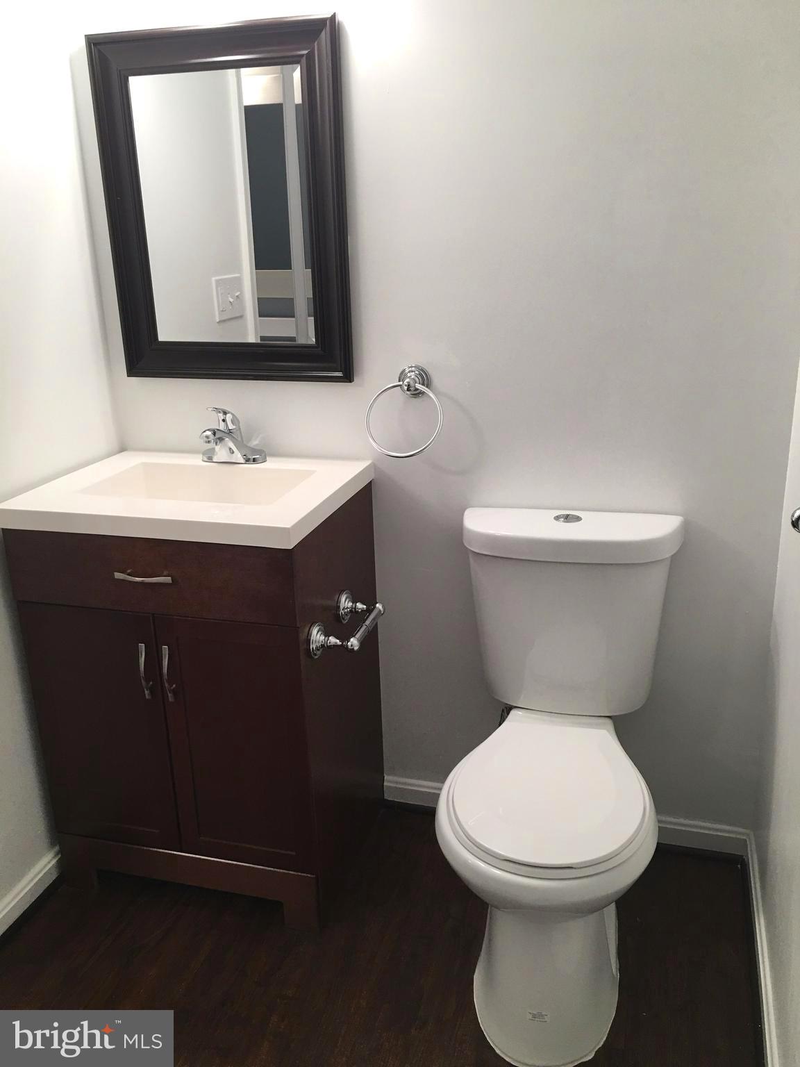 7635 Arbory Court, Unit 65 Laurel, MD 20707 - Photo 21 of 33 a bathroom with a toilet sink and mirror