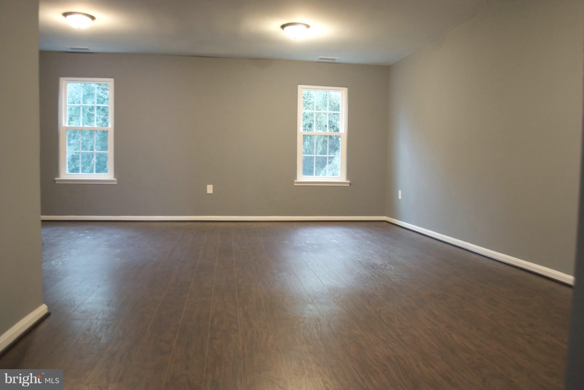 7635 Arbory Court, Unit 65 Laurel, MD 20707 - Photo 22 of 33 an empty room with wooden floor and windows