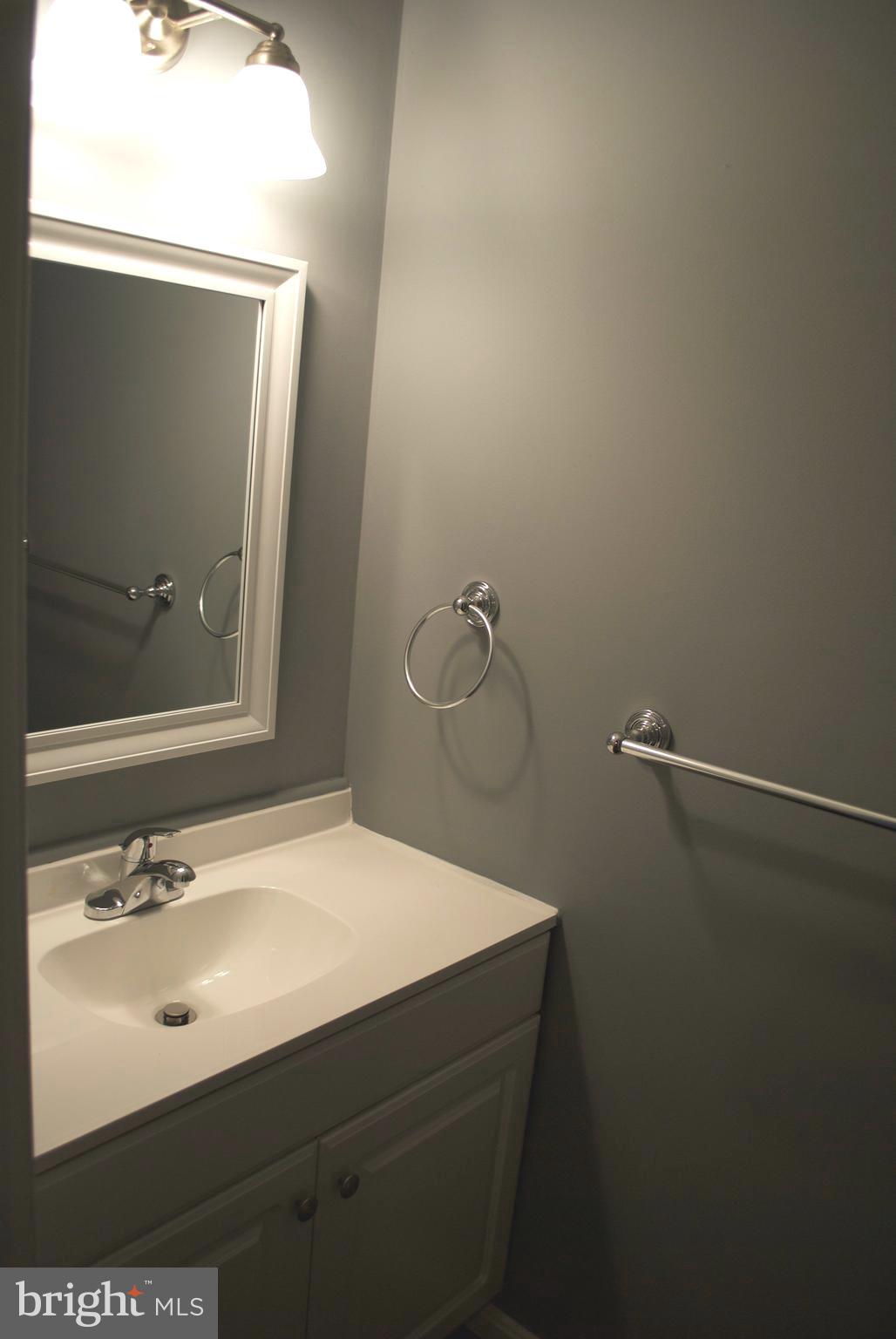 7635 Arbory Court, Unit 65 Laurel, MD 20707 - Photo 23 of 33 a bathroom with a sink and mirror