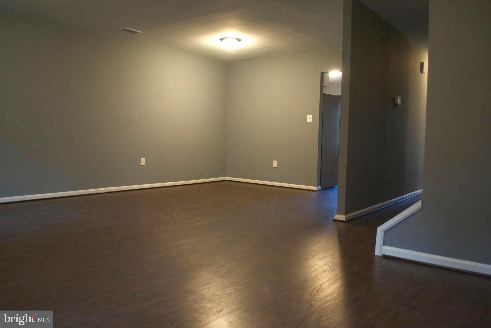 7635 Arbory Court, Unit 65 Laurel, MD 20707 - Photo 24 of 33 an empty room with wooden floor and windows