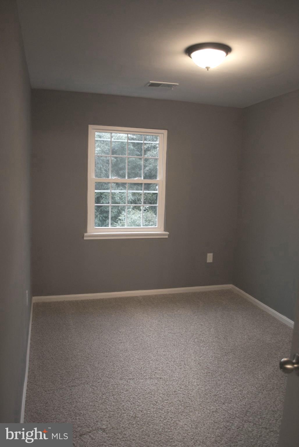7635 Arbory Court, Unit 65 Laurel, MD 20707 - Photo 28 of 33 an empty room with a empty space and windows