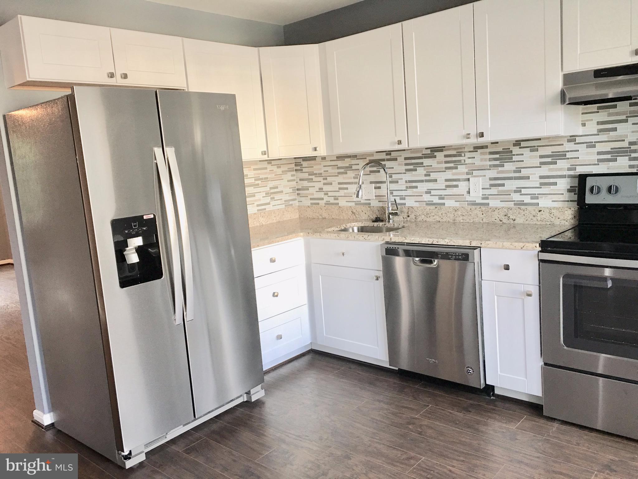 7635 Arbory Court, Unit 65 Laurel, MD 20707 - Photo 4 of 33 a kitchen with white cabinets white stainless steel appliances and sink