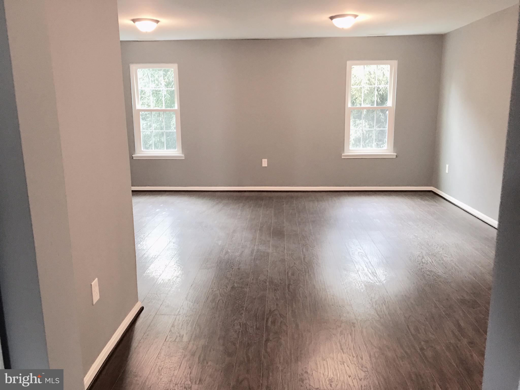 7635 Arbory Court, Unit 65 Laurel, MD 20707 - Photo 8 of 33 an empty room with wooden floor and windows