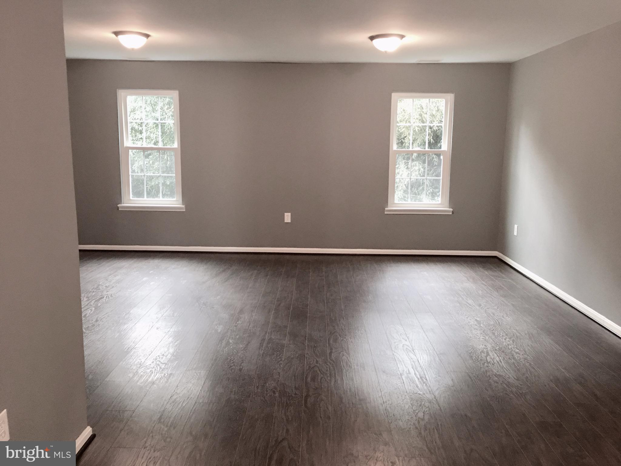 7635 Arbory Court, Unit 65 Laurel, MD 20707 - Photo 9 of 33 an empty room with wooden floor and windows