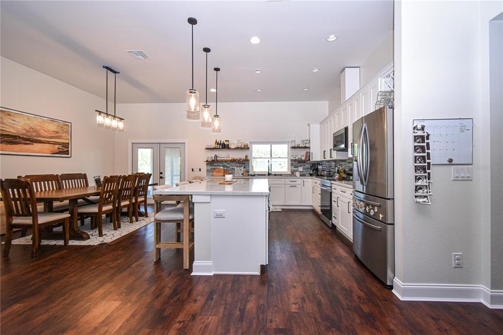 7890 Southwest 129th Avenue Cedar Key, FL 32625 - Photo 12 of 45 a kitchen with white cabinets and stainless steel appliances