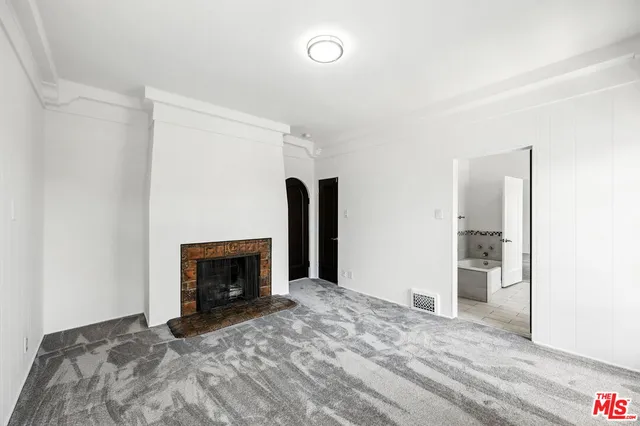 a big room with closet and a fireplace