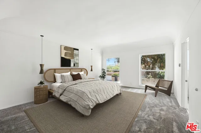 a bedroom with a bed and chair