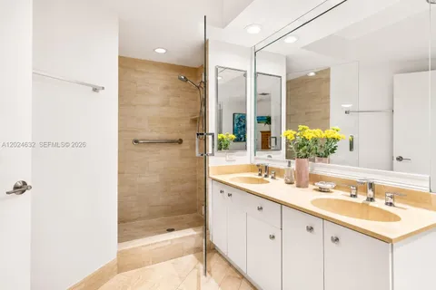 a bathroom with a shower sink and mirror