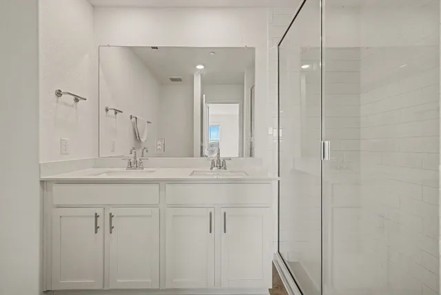 a bathroom with double sink and mirror