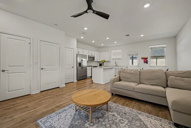 a living room with furniture or kitchen view and a wooden floor