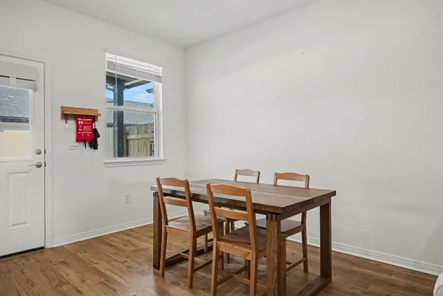 a view of a dining room with furniture and wooden floor