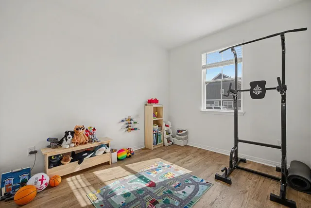 a bed room with a bed and gym equipment