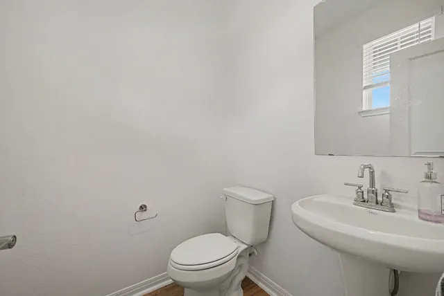 a white toilet sitting next to a white sink