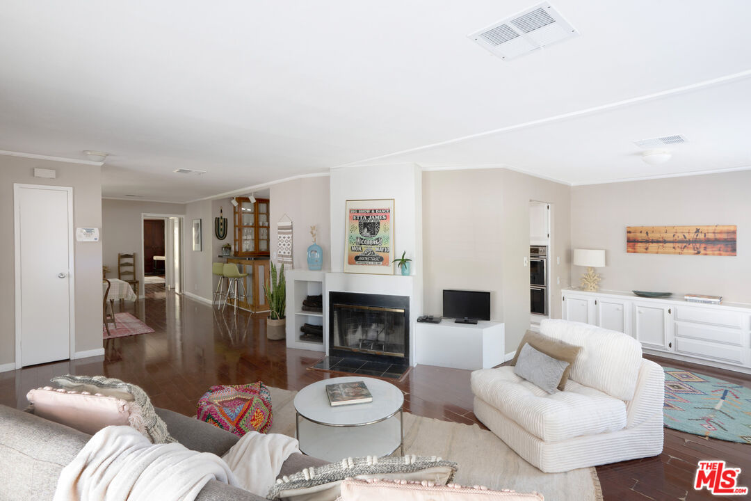 1183 Aztec Topanga, CA 90290 - Photo 19 of 68 a living room with furniture and a fireplace
