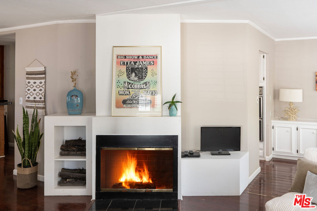 1183 Aztec Topanga, CA 90290 - Photo 20 of 68 a living room with furniture a flat screen tv and a fireplace