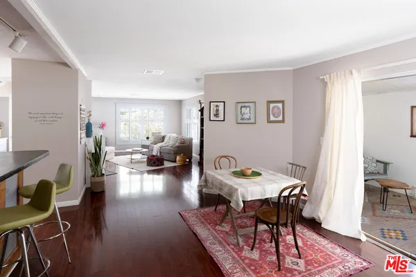 a view of a patio with couple of chairs and potted plants