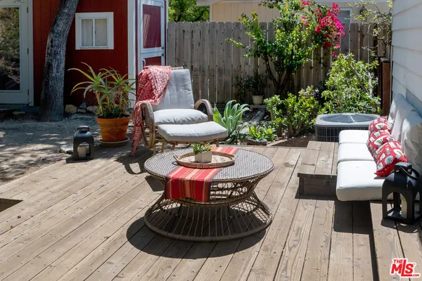 a view of a hallway with furniture and a window