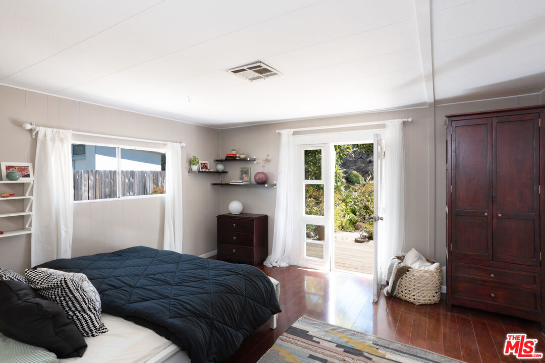 1183 Aztec Topanga, CA 90290 - Photo 30 of 68 a bedroom with a bed and wooden floor