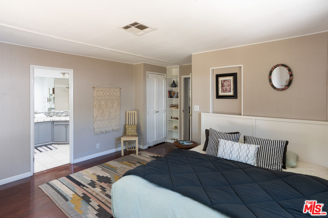 1183 Aztec Topanga, CA 90290 - Photo 31 of 68 a bedroom with a bed and painting on the wall