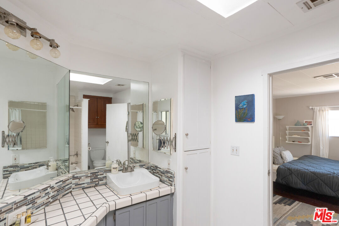 1183 Aztec Topanga, CA 90290 - Photo 33 of 68 a en suite bathroom with a sink and a mirror