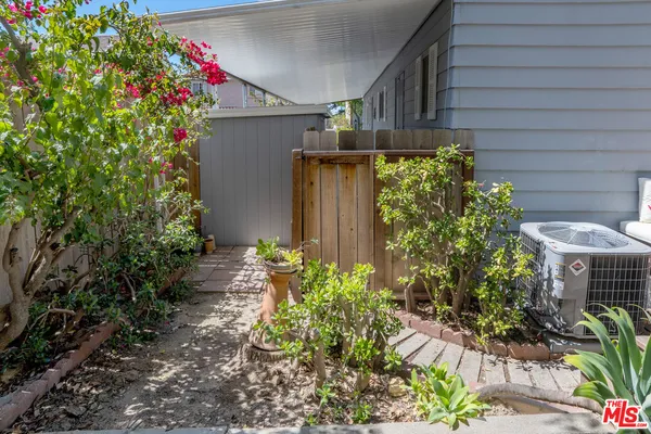 a bedroom with furniture and a large window