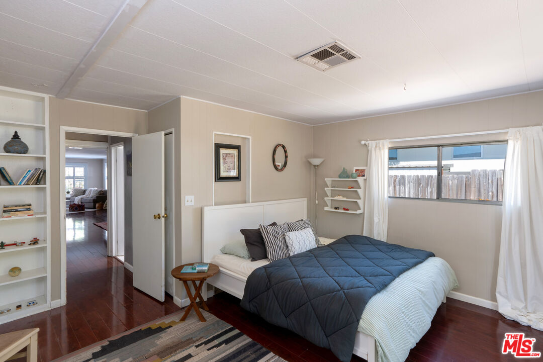 1183 Aztec Topanga, CA 90290 - Photo 48 of 68 a bedroom with a bed and wooden floor
