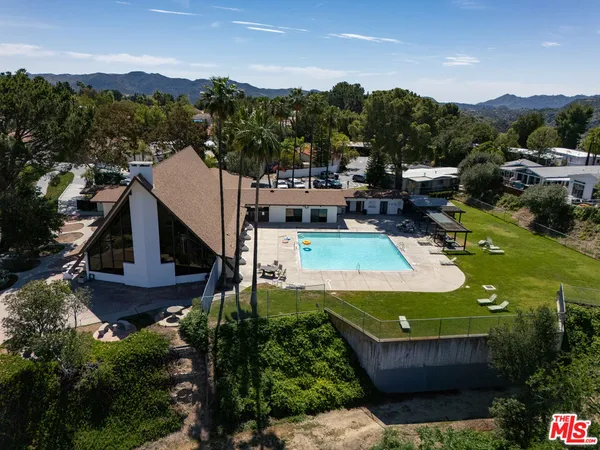 an aerial view of a house with a mountain view