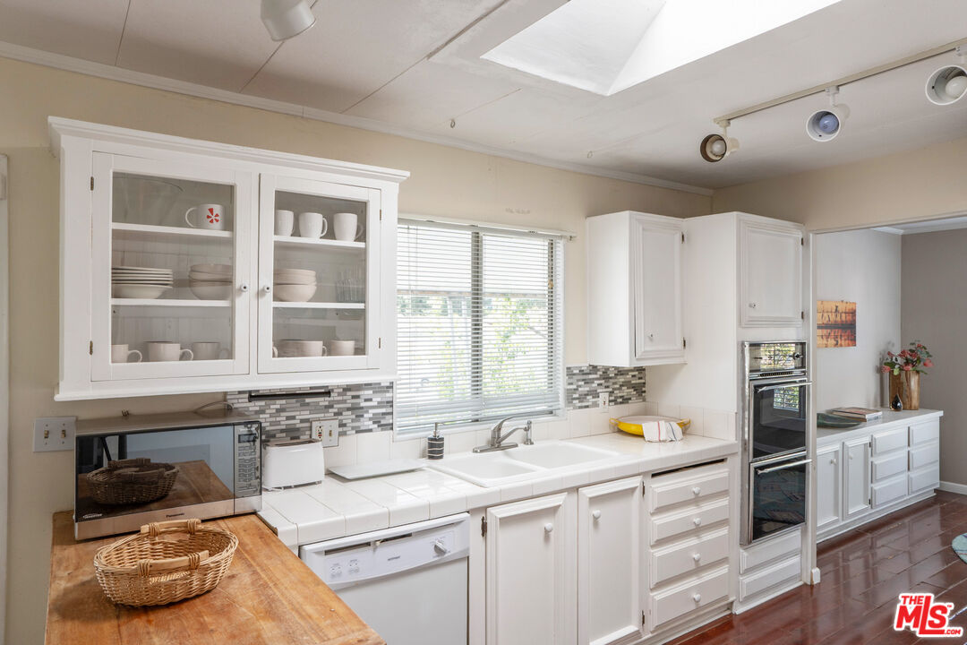 1183 Aztec Topanga, CA 90290 - Photo 5 of 68 a kitchen with stainless steel appliances a sink a stove and a window
