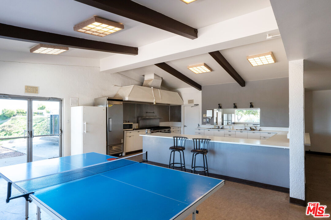 1183 Aztec Topanga, CA 90290 - Photo 60 of 68 a kitchen with stainless steel appliances granite countertop a sink dishwasher stove top oven and refrigerator with wooden floor