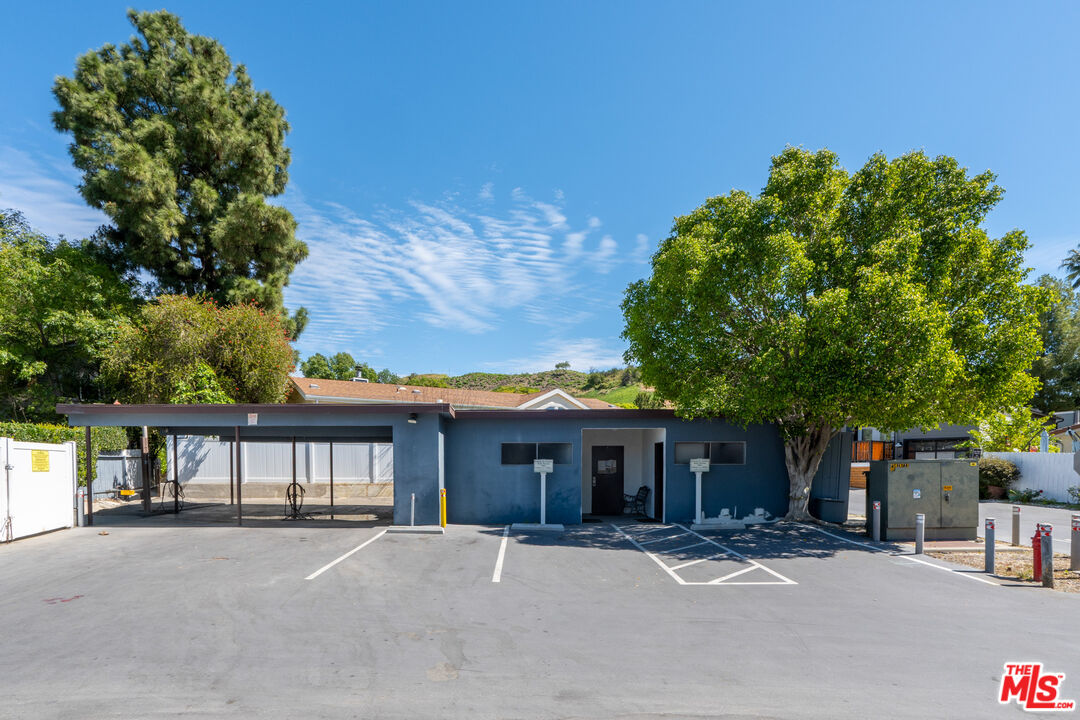 1183 Aztec Topanga, CA 90290 - Photo 65 of 68 a front view of a house with a garden and trees